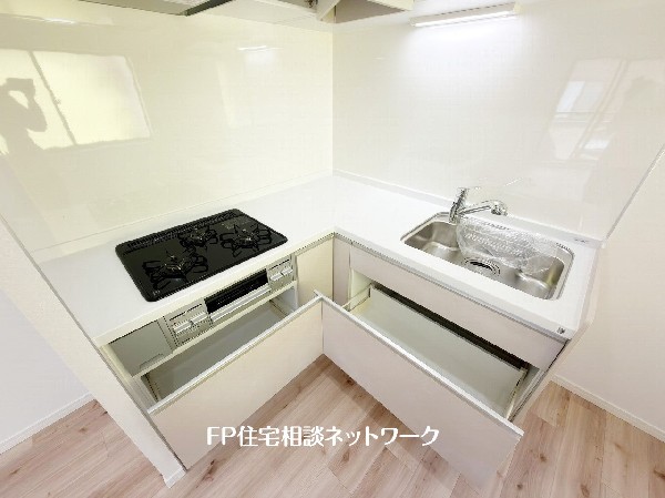スライド収納付きのシステムキッチン。料理器具なども収納できて出し入れもスムーズ。収納量もたっぷりなので料理器具やストック調味料なども入れられる。